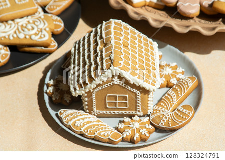 Decorated Gingerbread House and Cookies Decorated Gingerbread House and Cookies 128324791