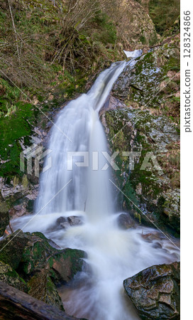 Majestic Allerheiligen Waterfalls: Serene Long Exposure Cascade in Black Forest National Park Germany. Scenic Forest Stream Flows Through Lush Greenery and Moss Covered Rocks Creating Ethereal 128324866