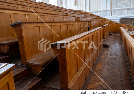 Rows of Wooden Benches in Lecture Hall. University auditorium classroom 128324884