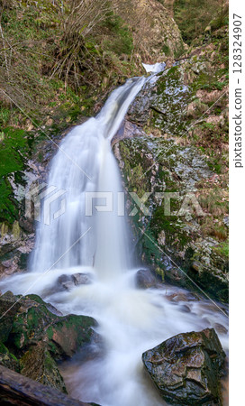 Majestic Allerheiligen Waterfalls: Serene Long Exposure Cascade in Black Forest National Park Germany. Scenic Forest Stream Flows Through Lush Greenery and Moss Covered Rocks Creating Ethereal Majestic Allerheiligen Waterfalls: Serene Long Exposure Cascade in Black Forest National Park Germany. Scenic Forest Stream Flows Through Lush Greenery and Moss Covered Rocks Creating Ethereal 128324907