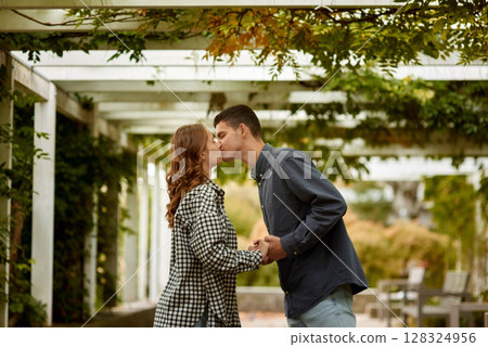 Young Cute Female Hugs Boyfriend. In Autumn Outdoor. Lovers Walking in Park. Attractive Funny Couple. Lovestory in Forest. Man and Woman. Cute Lovers in the Park. Family Concept. Happy Couple. 128324956