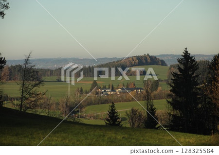 Beautiful landscape with a small town in the distance Beautiful landscape with a small town in the distance 128325584