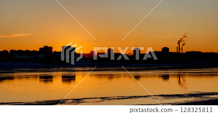 A beautiful orange sunset with a black silhouette of city buildings A beautiful orange sunset with a black silhouette of city buildings 128325811