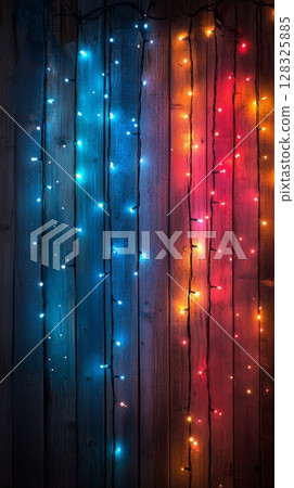 Colorful string lights on wooden background, festive decoration concept 128325885
