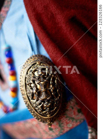 Decoration of clothes in the Slavic ancient style. Vikings. Multi-colored beads, simple fabrics of rich colors. Pastiche. Decoration of clothes in the Slavic ancient style. Vikings. Multi-colored beads, simple fabrics of rich colors. Pastiche. 128326166