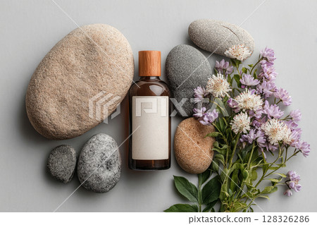 Aromatherapy set with stones, flowers and oil bottle on textured background 128326286
