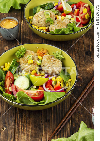 Buddha bowl with fish cakes, healthy food. Buddha bowl with fish cakes, healthy food. 128326875