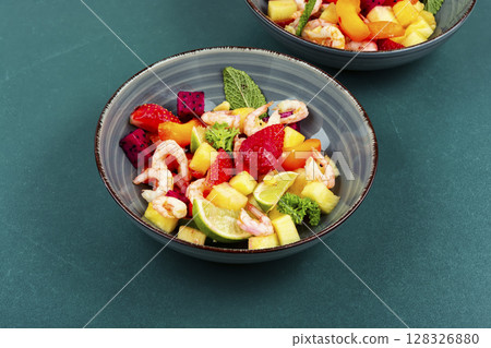 A vibrant shrimp salad featuring tropical fruits. 128326880