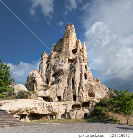 Carved out, natural rock formation, revealing cave dwellings and windows, in Goreme Open-Air Museum, Cappadocia, Turkey Carved out, natural rock formation, revealing cave dwellings and windows, in Goreme Open-Air Museum, Cappadocia, Turkey 128326982