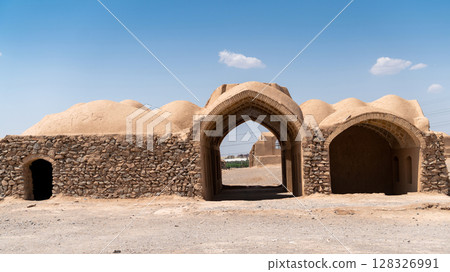 Ancient Zoroastrian Towers of Silence in Yazd, elevated circular structures on arid hills, under a vast sky 128326991