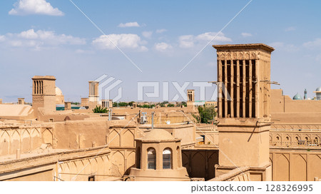 Yazd cityscape featuring traditional mudbrick buildings, iconic windcatcher towers, and Iranian architecture Yazd cityscape featuring traditional mudbrick buildings, iconic windcatcher towers, and Iranian architecture 128326995