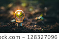 A light bulb containing a small green plant emerges from dark soil, representing the fusion of technology and nature in green energy initiatives. 128327096