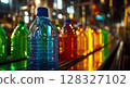 Brightly colored plastic bottles move along a conveyor belt in a water-filling plant, highlighting a blue-capped bottle with yellow liquid. 128327102