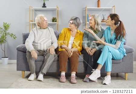 Nurse And Seniors Playing Who I Am Game At Nursing Home Nurse And Seniors Playing Who I Am Game At Nursing Home 128327211