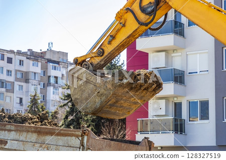 an excavator fills an excavator fills 128327519