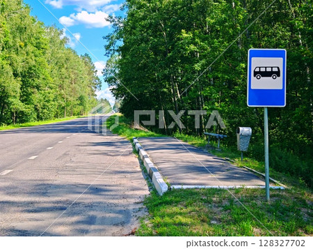 Empty Bus stop located on a side road somewhere in the countryside. Summer season. bus stop on a rural road, in the middle of the forest Empty Bus stop located on a side road somewhere in the countryside. Summer season. bus stop on a rural road, in the middle of the forest 128327702