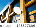 Exterior View of Modern Business Building Facade with Empty Round Signage Spotlighting Architectural Design 128327806