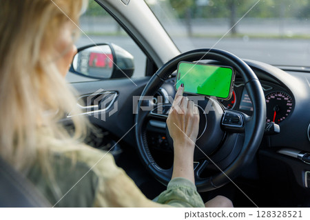 A Woman Using Her Smartphone While Driving: A Close-Up View of Modern Driving and Distraction in Today s Fast-Paced World 128328521