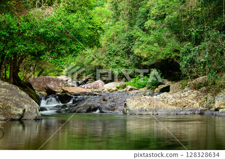 Along the Crystal Cascades near Cairns in Far North Queensland, locals and tourists enjoy swimming, hiking, picnicking, and exploring lush rainforest and freshwater streams. 128328634
