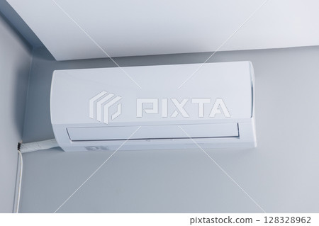 Modern Sleek Air Conditioning Unit Mounted on Wall, Ideal for Efficient Cooling in Home or Office Environments, Provides Comfortable Climate Control and Energy Efficiency 128328962