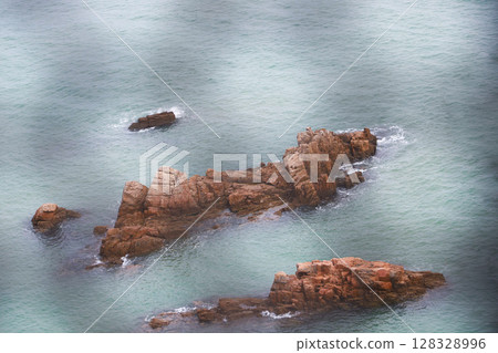 Serene Coastal Landscape Featuring Unique Rocky Formations Surrounded by Calm Waters in a Peaceful Seaside Setting Perfect for Nature Lovers and Avid Photographers Serene Coastal Landscape Featuring Unique Rocky Formations Surrounded by Calm Waters in a Peaceful Seaside Setting Perfect for Nature Lovers and Avid Photographers 128328996