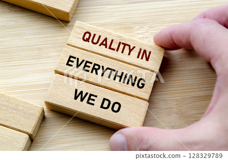 Quality in everything message held with both hands symbolizes attention to detail and pride in craftsmanship Quality in everything message held with both hands symbolizes attention to detail and pride in craftsmanship 128329789
