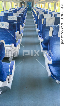 Spacious and Comfortable Train Interior with Blue Seating and Clean Aisles for a Relaxing Journey Experience in Modern Rail Travel 128329830