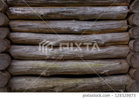 Close-Up View of Wooden Logs Stacked Together, Showcasing Natural Texture and Grain Patterns for Rustic Aesthetic Pleasure 128329873