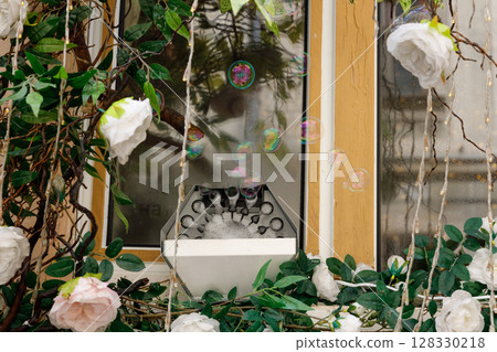 Charming Decorative Setup Featuring Faux Roses, Bubbles, and Natural Elements Captured in a Delightful Scene with an Inviting Ambiance 128330218