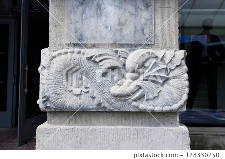 Intricate Stone Relief on a Building Corner Showcasing Elegant Patterns and Designs Inspired by Ocean Life, Illustrating the Artistry of Architectural Sculptures from a Bygone Era Intricate Stone Relief on a Building Corner Showcasing Elegant Patterns and Designs Inspired by Ocean Life, Illustrating the Artistry of Architectural Sculptures from a Bygone Era 128330250