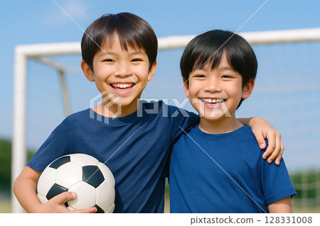 Smiling elementary school children with soccer balls 128331008