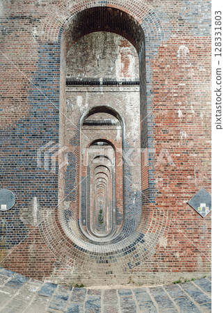 The semi-circular arches vaulting supporting brick piers, composed of traditional red bricks topped with smooth limestone 128331803