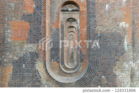 The semi-circular arches vaulting supporting brick piers, composed of traditional red bricks topped with smooth limestone 128331806