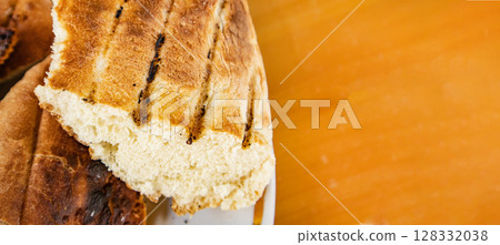 Bits of delicious toasted flatbread, on tabletop, space for text on right, banner 128332038