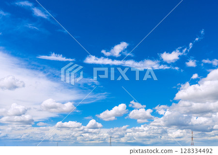 Yokohama cityscape in Japan, with cumulus clouds and steel towers shining against the blue sky (July 10th) 128334492