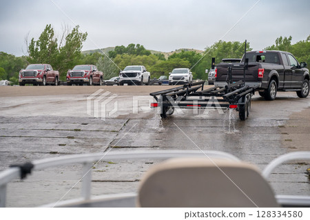 View from inside a boat as a trailer is backed down a ramp to load. View from inside a boat as a trailer is backed down a ramp to load. 128334580