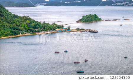 July 5 2025 Scenic View of Green Islands in a Beautiful Blue Sea by Mountains 128334590