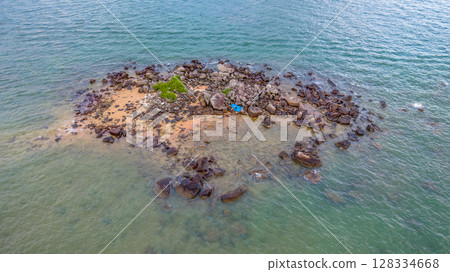 July 5 2025 Coastal Beach with Clear Water and Rock Formations in Natural Setting 128334668