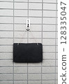 Information plate on the tile wall at the entrance 128335047
