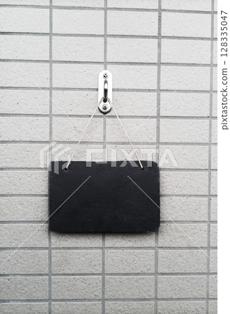 Information plate on the tile wall at the entrance 128335047