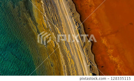 Red salt sea lake, at winter, village Alyki, Boeotia, Greece. 128335115