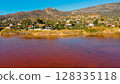 Red salt sea lake, at winter, village Alyki, Boeotia, Greece. 128335118