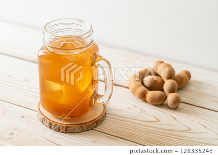 Delicious sweet drink tamarind juice and ice cube Delicious sweet drink tamarind juice and ice cube 128335243