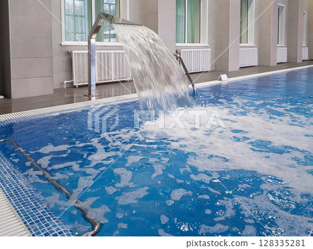 Whirlpool installation in an indoor pool, close-up, for relaxing and massaging the neck and back 128335281