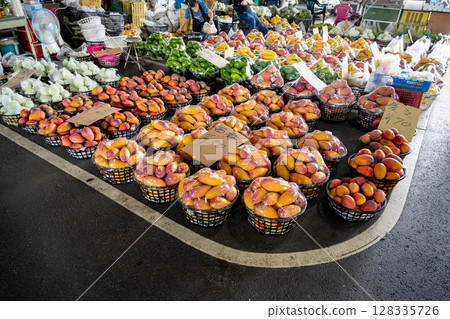 Tainan, Taiwan - June 30, 2025: Yujing water fruit market fresh mango display. The market is Taiwan's main fruit producing area, during the summer fruit season. 128335726