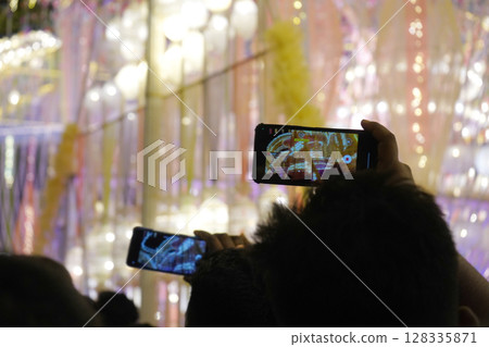 Framing the Festivities in Phones in the Pandal Crowd 128335871