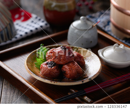 A photo of Kishu Nankou plums with dried bonito plums elegantly arranged on Japanese tableware 128336147