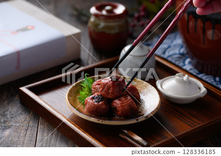 A luxurious Japanese-style presentation of pickled plums with a tranquil Japanese background 128336185