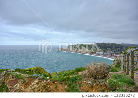 Panoramic view of Etretat town and cliffs from coastal trail Panoramic view of Etretat town and cliffs from coastal trail 128336278