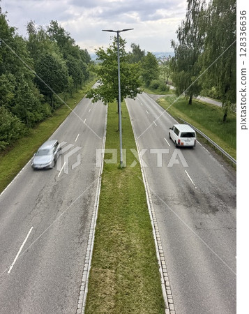Road with two lanes and a tree in the middle Road with two lanes and a tree in the middle 128336636